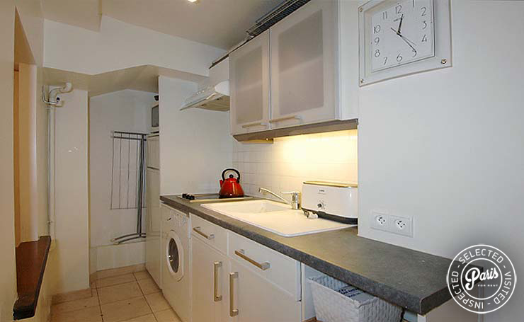 Kitchen with washer dryer at Place Bourg, Paris apartment rental, Marais