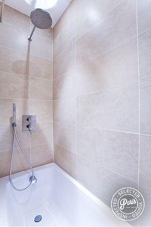 Bathtub with rain shower head at St Germain Bonaparte, Paris apartment rental, Saint Germain