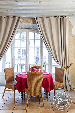 Dining table with window view at Bourg, apartment for rent in Paris, Marais
